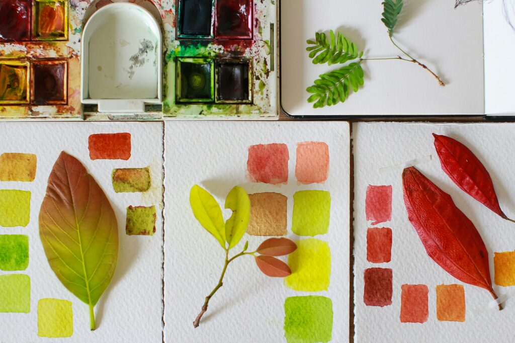 watercolor paint swatches matching green and orange fall leaves
