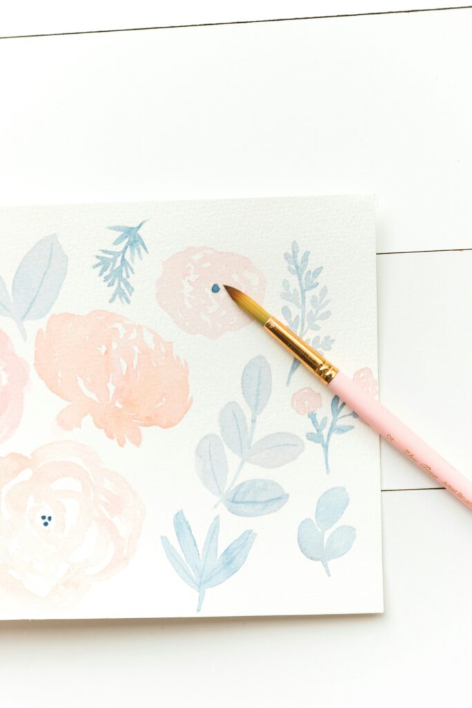 watercolor florals in pale peach, blue, and greens