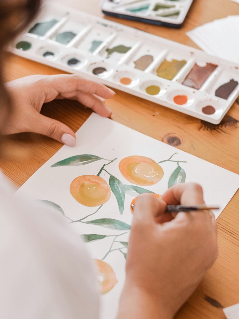 watercolor oranges on brown desk background